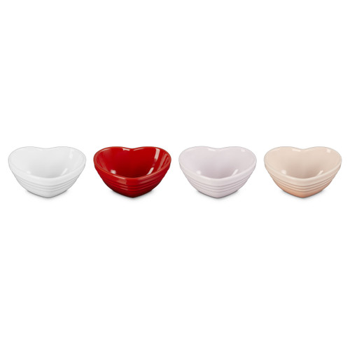 Set of four heart-shaped stoneware mini bowls in white, red, pale pink and blush, shown from the front on a white background.