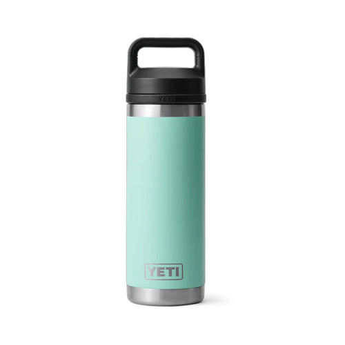 Angled view of a seafoam green YETI Rambler 18 oz bottle with black chug cap, shown on a white background.