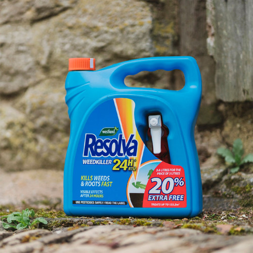 Blue plastic container of Resolva 24H weedkiller with red cap, placed on stone ground. Label reads "kills weeds fast" with a 20% extra offer.
