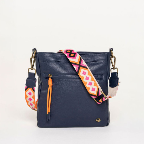 Navy leather crossbody bag with colourful woven strap in pink and orange geometric pattern, featuring a front zip pocket and orange zip pull.