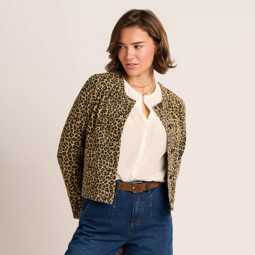 Front view of a cropped leopard print jacket with button fastening, styled over a cream blouse and wide-leg blue jeans.