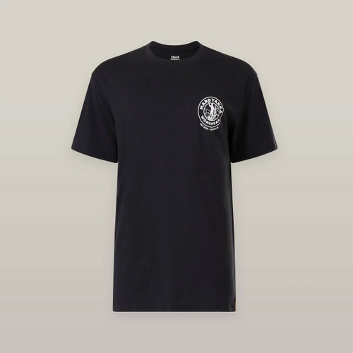 Black T-shirt against a beige background. It features a small circular logo on the left chest with text and a graphic, creating a minimalist, modern look.