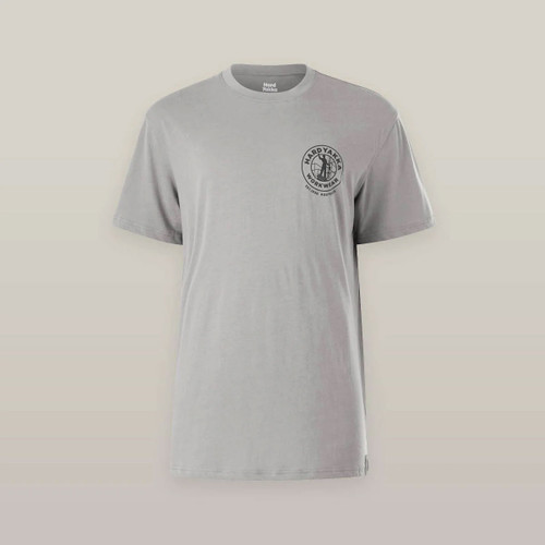 A grey T-shirt with a black circular logo on the left chest, featuring text and a simplistic design. The shirt has a plain background, conveying simplicity.