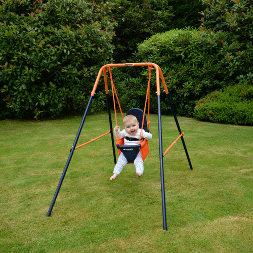 Baby sitting in a Hedstrom garden swing seat attached to a small metal swing frame on a lawn.