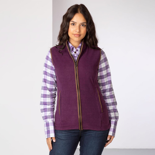 Woman wearing a berry coloured fleece gilet with brown trim over a checked shirt, shown from the front.