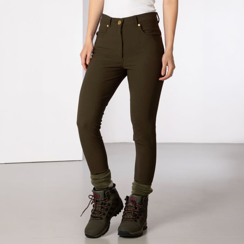 Front view of olive green walking trousers worn with outdoor boots, highlighting the slim fit and button fastening.
