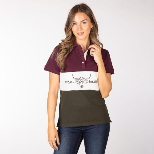 Front view of a model wearing a burgundy, white and olive colour-block polo shirt with Highland cow logo, styled with jeans.