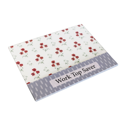 Rectangular worktop saver with white background and red poppy floral design, packaged with “Work Top Saver” label.