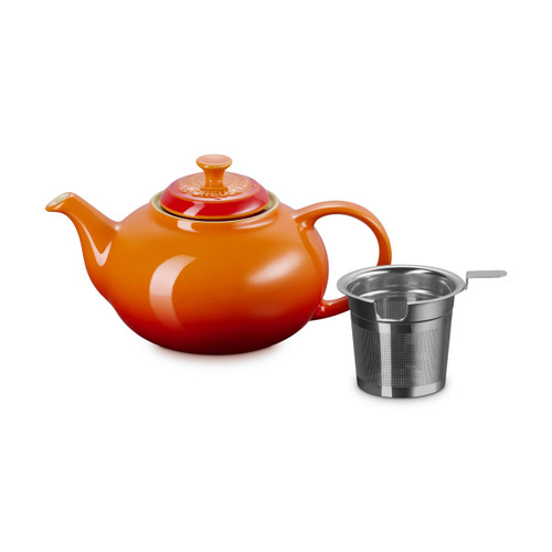 Orange gradient ceramic teapot with lid and removable stainless steel infuser on a plain background