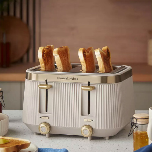 Cream Russell Hobbs Bronte 4-slice toaster with toast on a kitchen worktop.
