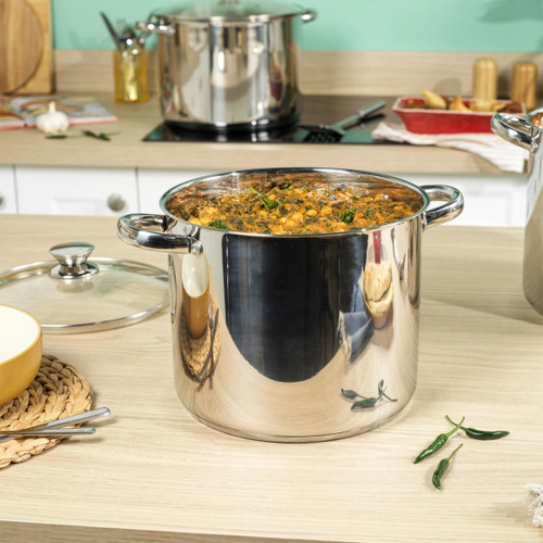 Russell Hobbs 24cm stainless steel stockpot filled with a hearty stew, displayed on a kitchen worktop with glass lid alongside.