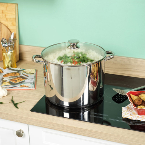 Large Russell Hobbs 30cm stainless steel stockpot with glass lid cooking vegetables on an induction hob.