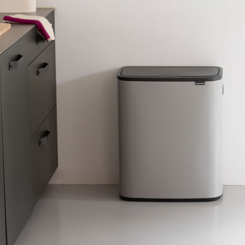 Brabantia Bo Touch Bin 60L in Mineral Concrete Grey positioned in a modern kitchen, featuring a compact floor-standing design with soft-touch lid.