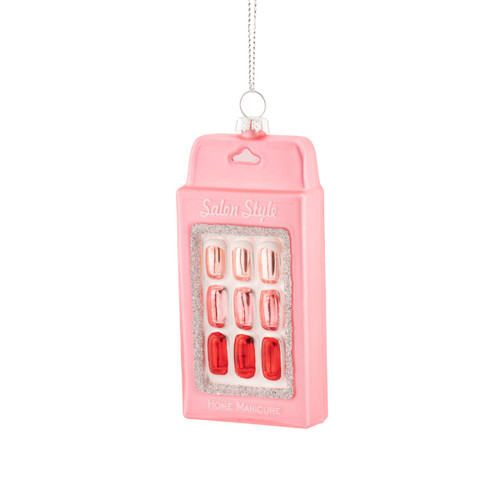 Glass Christmas tree ornament shaped like a pack of press-on nails, featuring a pastel pink backing card, glossy pink and red nail designs, silver glitter detailing and a hanging loop for festive display.