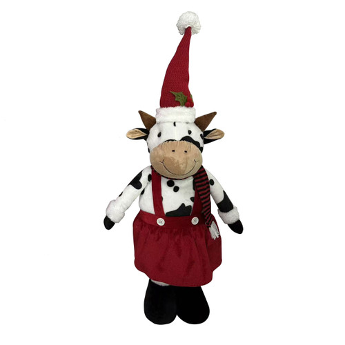 Festive cow Christmas decoration with black and white spotted design, wearing a red dress, striped scarf and tall Santa hat, ideal for seasonal home displays.