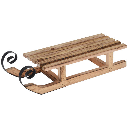 Rustic wooden decorative sleigh with slatted seat and curled metal runners, styled as a traditional winter and Christmas display piece on a light background.
