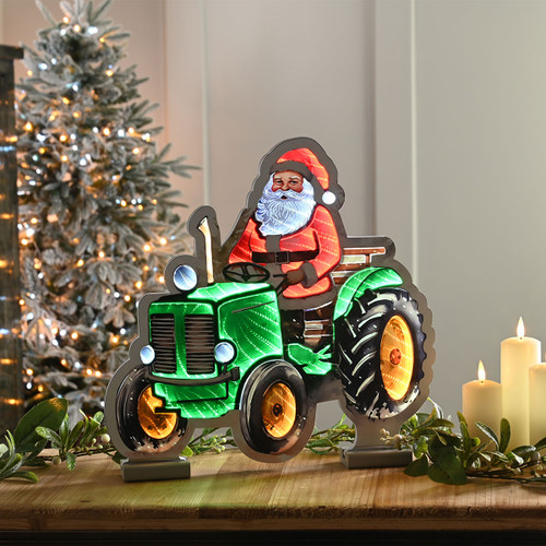 Illuminated infinity-effect Santa on a green tractor decoration, creating a festive 3D light display for Christmas.