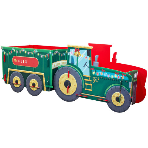Christmas-themed green toy tractor gift box with red interior, festive string lights, gold bell decoration and personalised “To: Alex” label, designed as a holiday gift container.