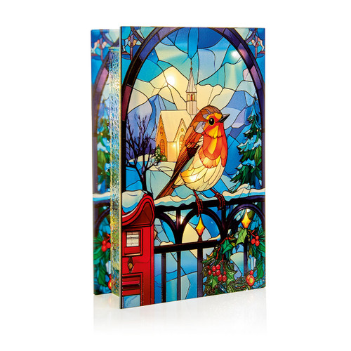 Illuminated stained glass effect Christmas robin decoration featuring a robin perched on a fence beside a red post box, with a snowy church and winter landscape in the background, designed as a freestanding light-up ornament for festive home décor.