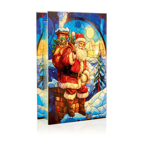 Illuminated stained glass effect Father Christmas decoration featuring Santa carrying a sack of presents while standing on a snowy rooftop beside a chimney under a moonlit winter sky, designed as a freestanding light-up ornament for festive home décor.