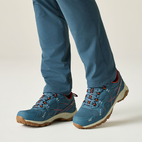 Model wearing blue waterproof hiking shoes with cushioned midsoles, breathable mesh uppers and durable grip soles, suitable for walking and outdoor adventures.