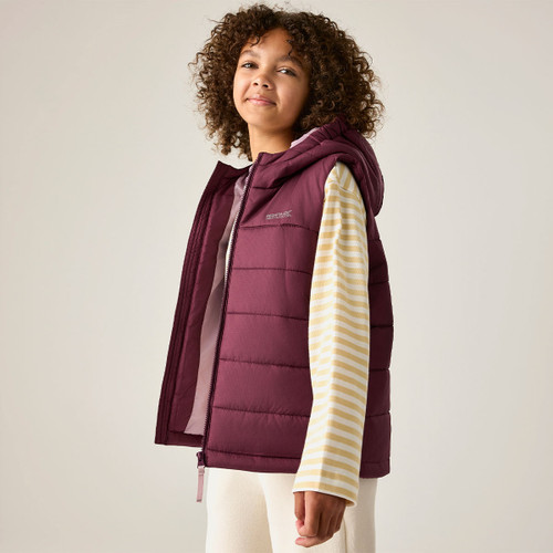Lifestyle image of the junior hooded padded gilet, showcasing the lightweight quilted design, full-zip fastening, insulated hood, and relaxed fit.