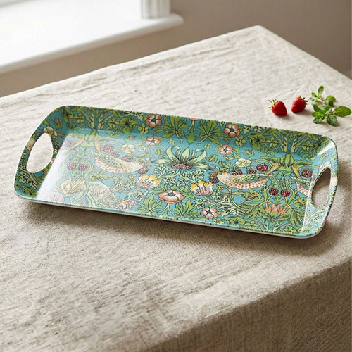 William Morris Strawberry Thief rectangular serving tray featuring the iconic bird, strawberry and floral pattern on a soft blue background. Designed with integrated carry handles and displayed on a linen-covered table alongside fresh strawberries.