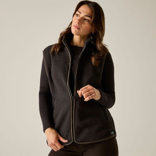 Woman wearing the Regatta women's dark chocolate Borg fleece gilet with a full zip and high collar.