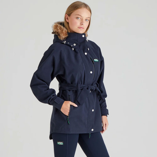 Front angled view of the Ridgeline women's Monsoon Nordic jacket in Navy with a faux fur-trimmed hood, adjustable waist belt and waterproof design.