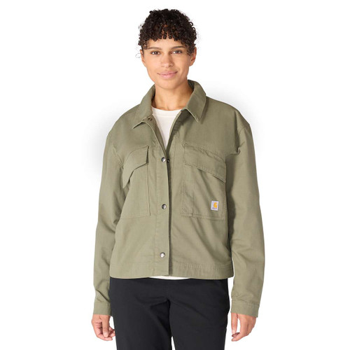 Women’s olive green Carhartt utility jacket worn by a model, featuring a pointed collar, snap front fastening and oversized chest pockets.