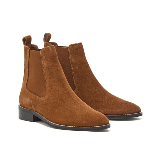 Pair of tan suede Chelsea boots with elastic side panels, low black heels, and pointed toes