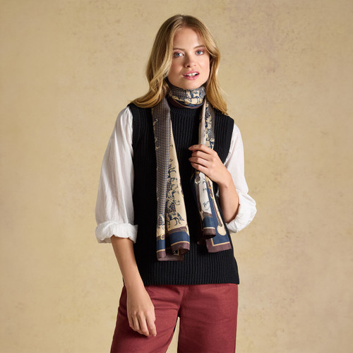Worn wrapped and draped around the neck, demonstrating an effortless way to add print and colour to layered outfits.