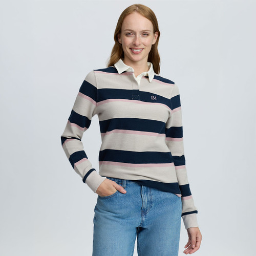 Woman modelling a LeMieux long-sleeve rugby shirt with cream, navy and pink stripes, white collar and LM chest logo, paired with blue jeans.