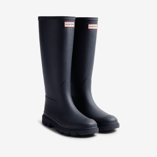 A pair of navy tall rubber boots with a Hunter logo on the front.
