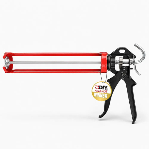 Award-winning red caulking gun being used to apply sealant around an interior window frame.