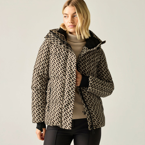 A woman in a patterned brown puffer jacket with a hood, styled over a beige turtleneck, against a light background.