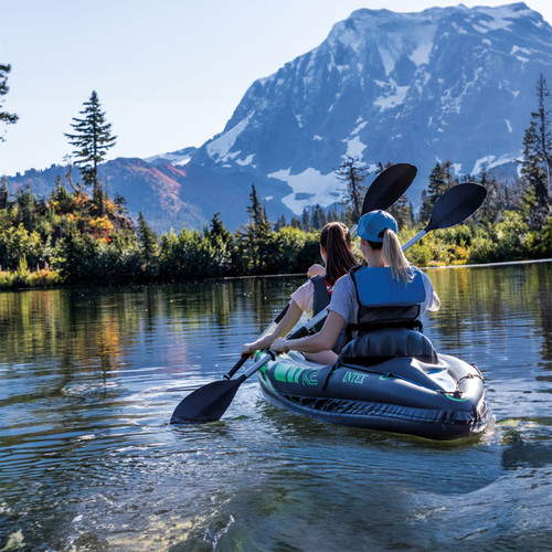 Two people paddling an Intex Challenger K2 inflatable kayak on a mountain lake