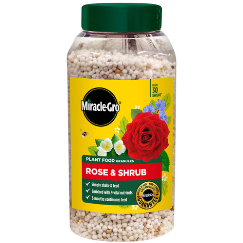 A container of Miracle-Gro plant food granules for roses and shrubs, featuring a red rose image on a yellow label. Promises easy use, nutrients, and long-lasting feed.