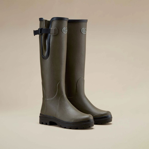 Le Chameau women’s tall olive green wellington boots with adjustable waterproof gussets and rugged black treaded soles.