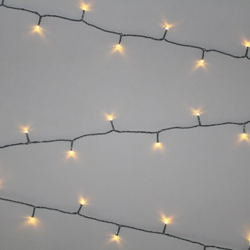 Warm white LED Christmas string lights on green cable, evenly spaced for decorating Christmas trees, garlands and indoor or outdoor festive displays.