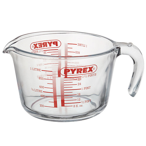 Pyrex Classic 1 litre clear glass measuring jug with handle, pouring spout and red metric and imperial measurement markings.