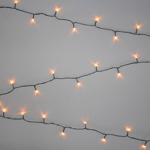 Antique white LED string lights with warm vintage-style bulbs on a green cable, displayed in parallel strands against a light grey background for festive indoor and outdoor decorating.