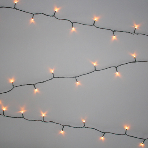 Antique white LED string lights with warm vintage-style bulbs on a green cable, displayed in parallel strands against a light grey background for festive indoor and outdoor decorating.
