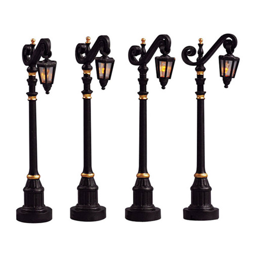 Set of four illuminated Victorian-style street lamps with black and gold detailing, ideal for Christmas village displays, model railways and festive winter scenes.