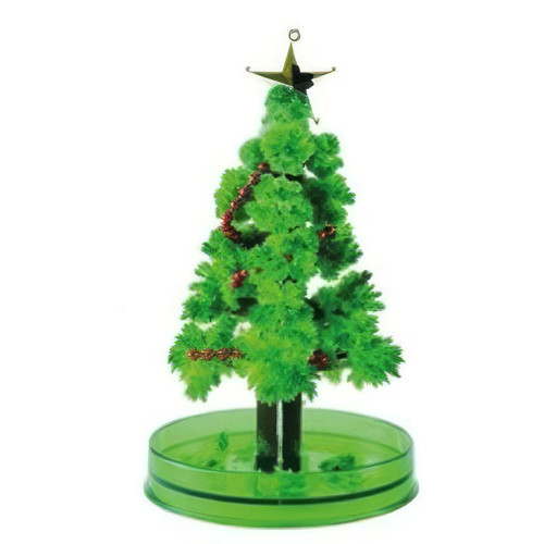 Magic growing Christmas tree science kit featuring a crystal-covered miniature Christmas tree with star topper, displayed on a green base against a light grey background.