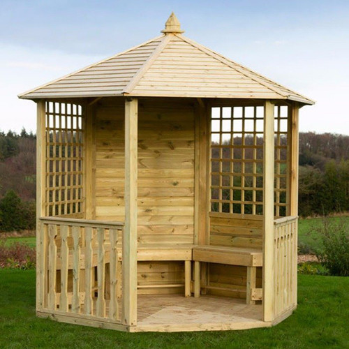 Hexagonal wooden garden gazebo with a pitched roof, lattice side panels and built-in bench seating, positioned on a lawn.