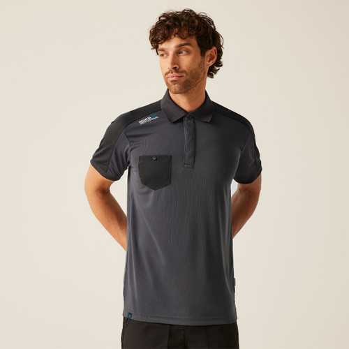 Men’s dark grey performance polo shirt with black shoulder panels, short sleeves, and chest pocket featuring button detail, worn as modern workwear uniform