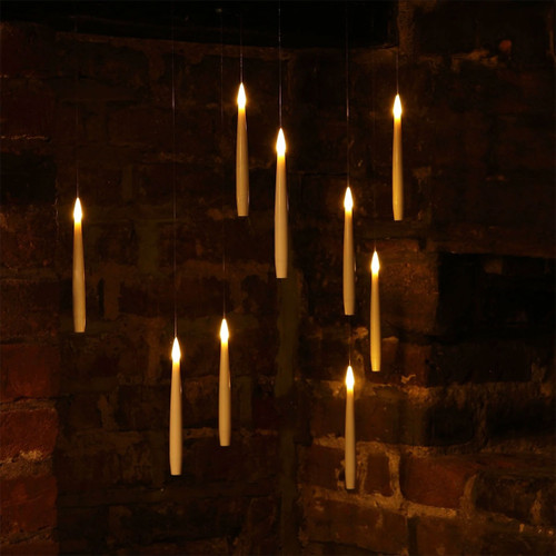 A collection of 10 LED candles hanging from clear wire.