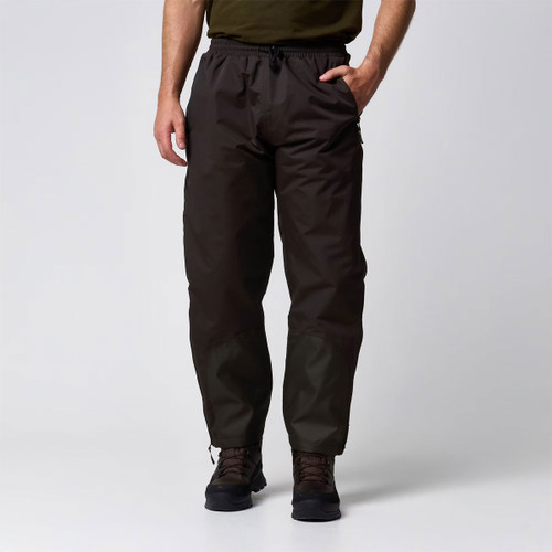 Man wearing dark brown outdoor trousers with an elasticated drawstring waist and hiking boots, shown from the front.