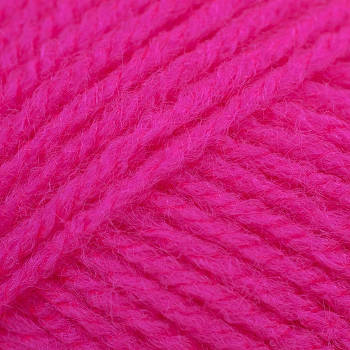 Close-up of tightly twisted bright pink yarn strands arranged diagonally, showing the texture and weave of the wool.